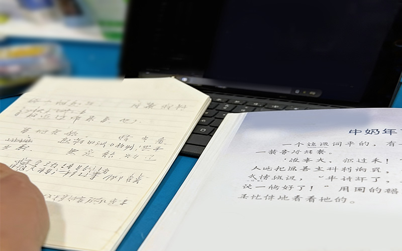Student practicing Chinese sentence structure with workbook and tablet