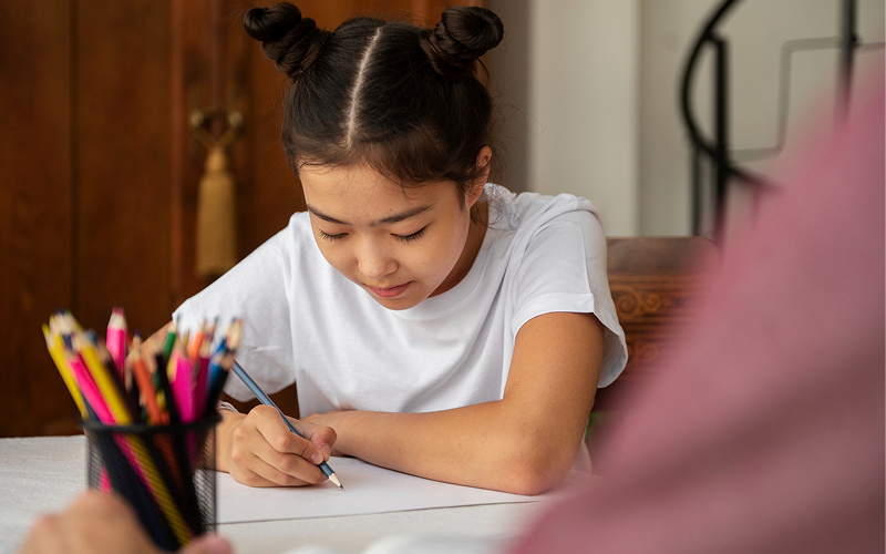 Young student doing homework.