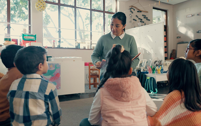Teacher sharing stories and nursery rhymes with students in class.