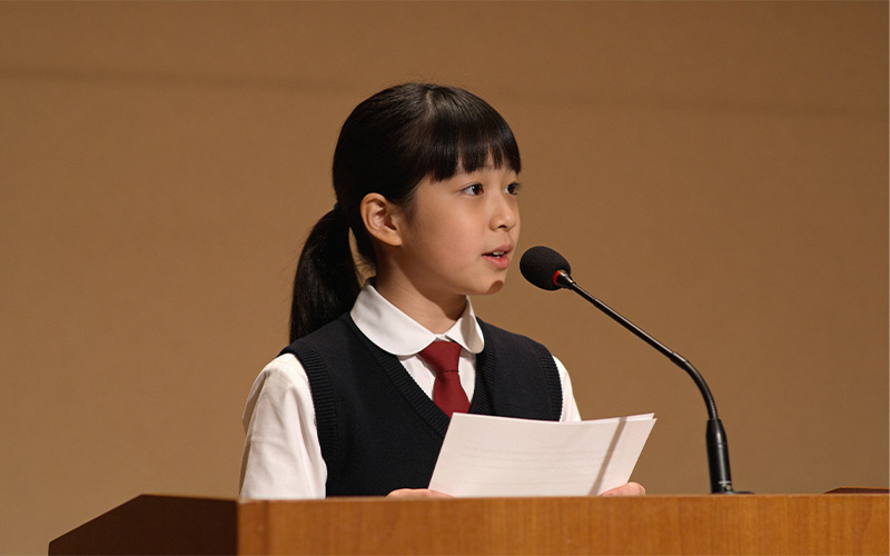Student giving speech at podium.