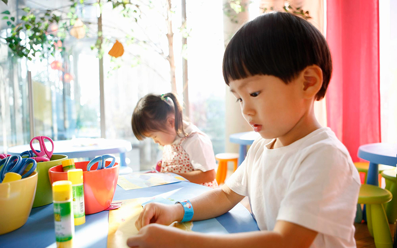 Young learners engaged in hands-on creative game-based learning.